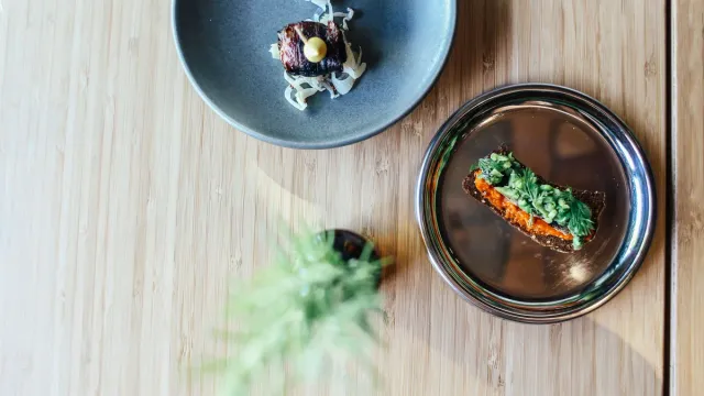 Restaurant dishes arranged on contrasting ceramic plates.