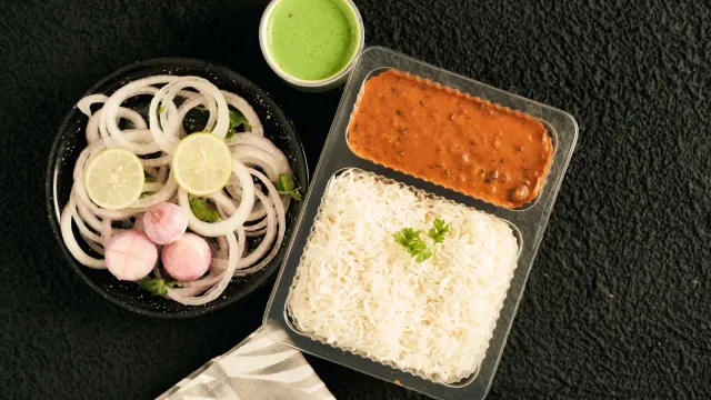 Rice and curry served with onion and lime.