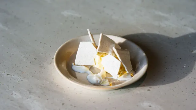 A pale plated dessert in side window light.