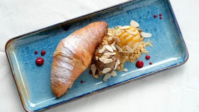 A fish dish on a blue ceramic plate.