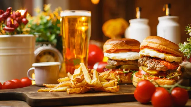 Burgers and fries on a lively restaurant table.