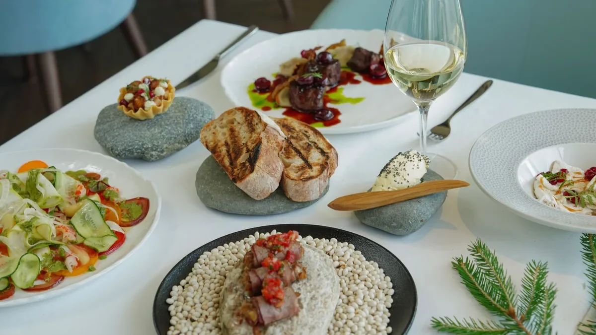 Several restaurant dishes arranged across a dining table.