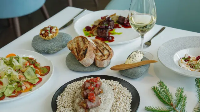 Several restaurant dishes arranged across a dining table.